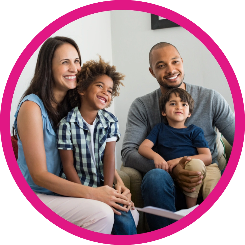 family with two kids sitting on a sofa in a counselling session