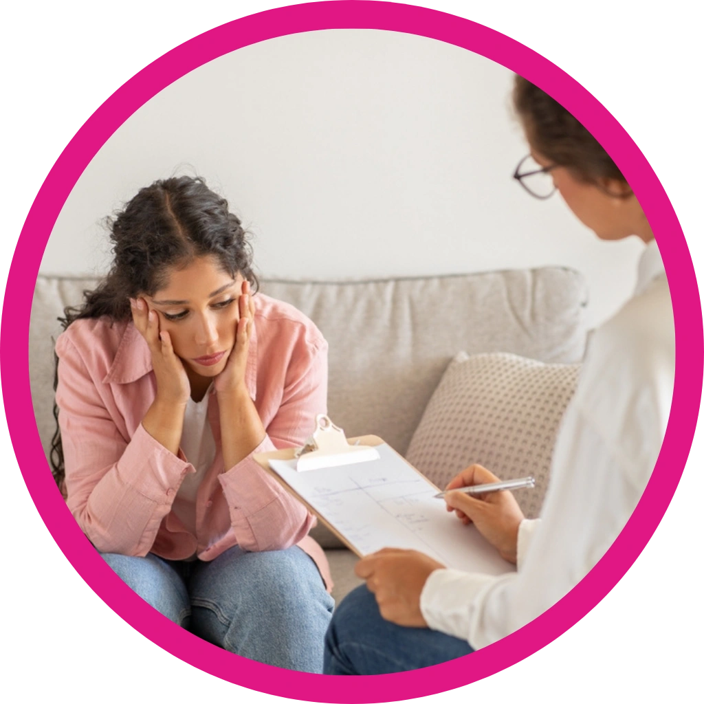 women looking distressed, sitting on a sofa in a counseling session